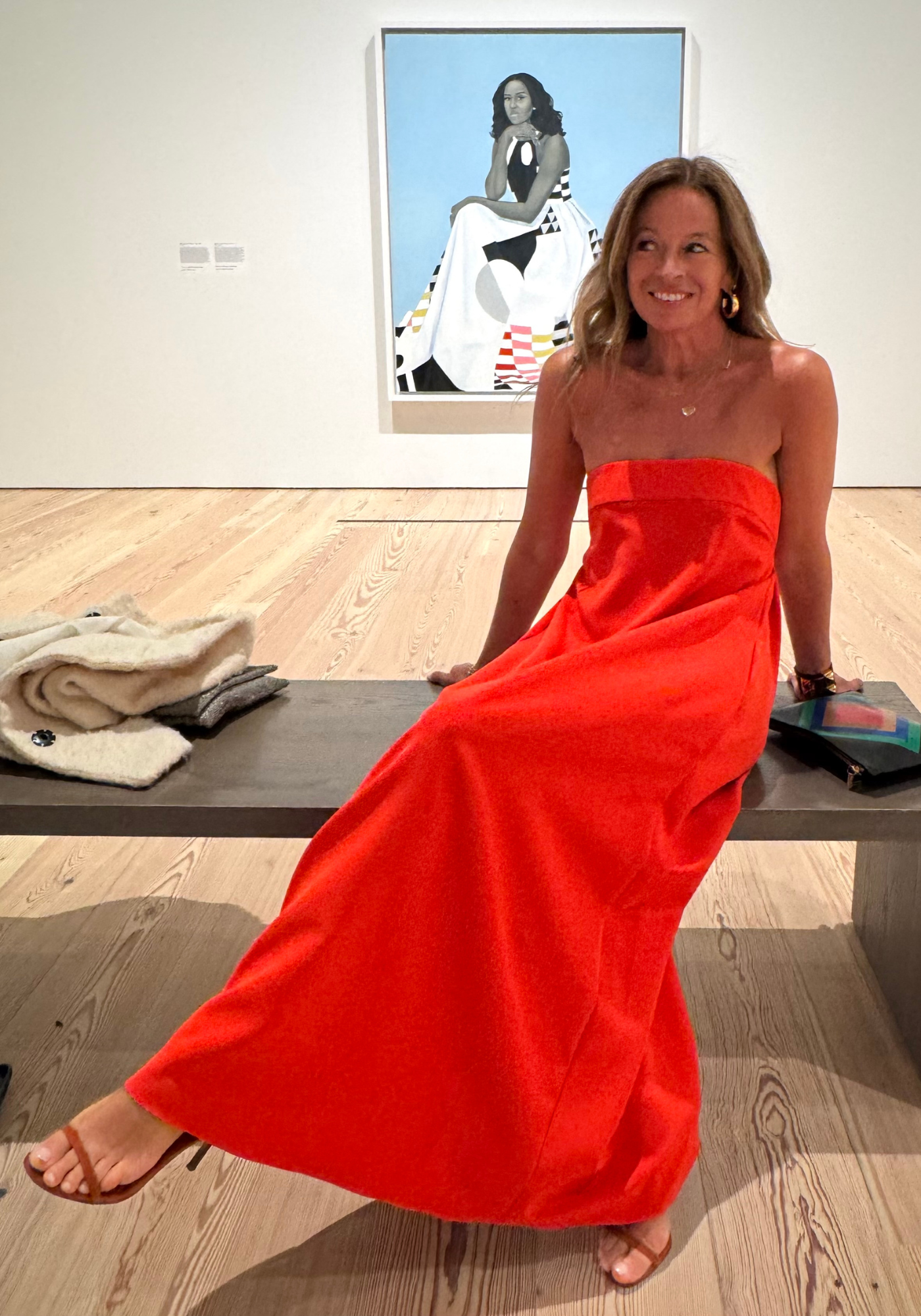 Michelle Smith in front of portrait of Michelle Obama. 