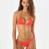 Woman wearing a red bikini on a white background