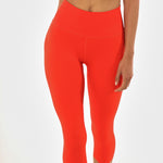 Front view, close up of poppy colored women's leggings. 