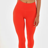 Front view, close up of poppy colored women's leggings. 