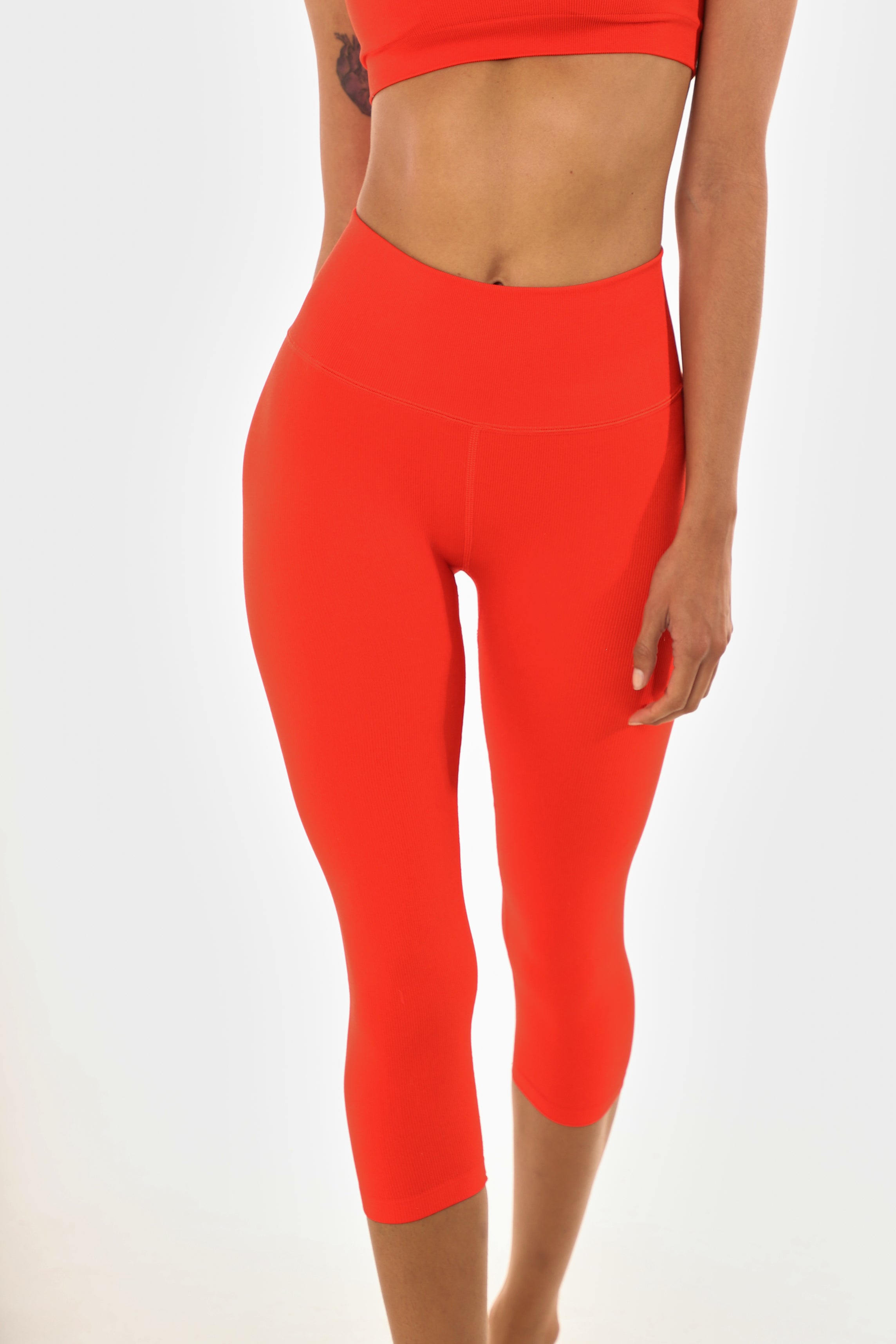 Front view, close up of poppy colored women's leggings. 