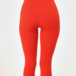 Back view of poppy colored women's leggings.