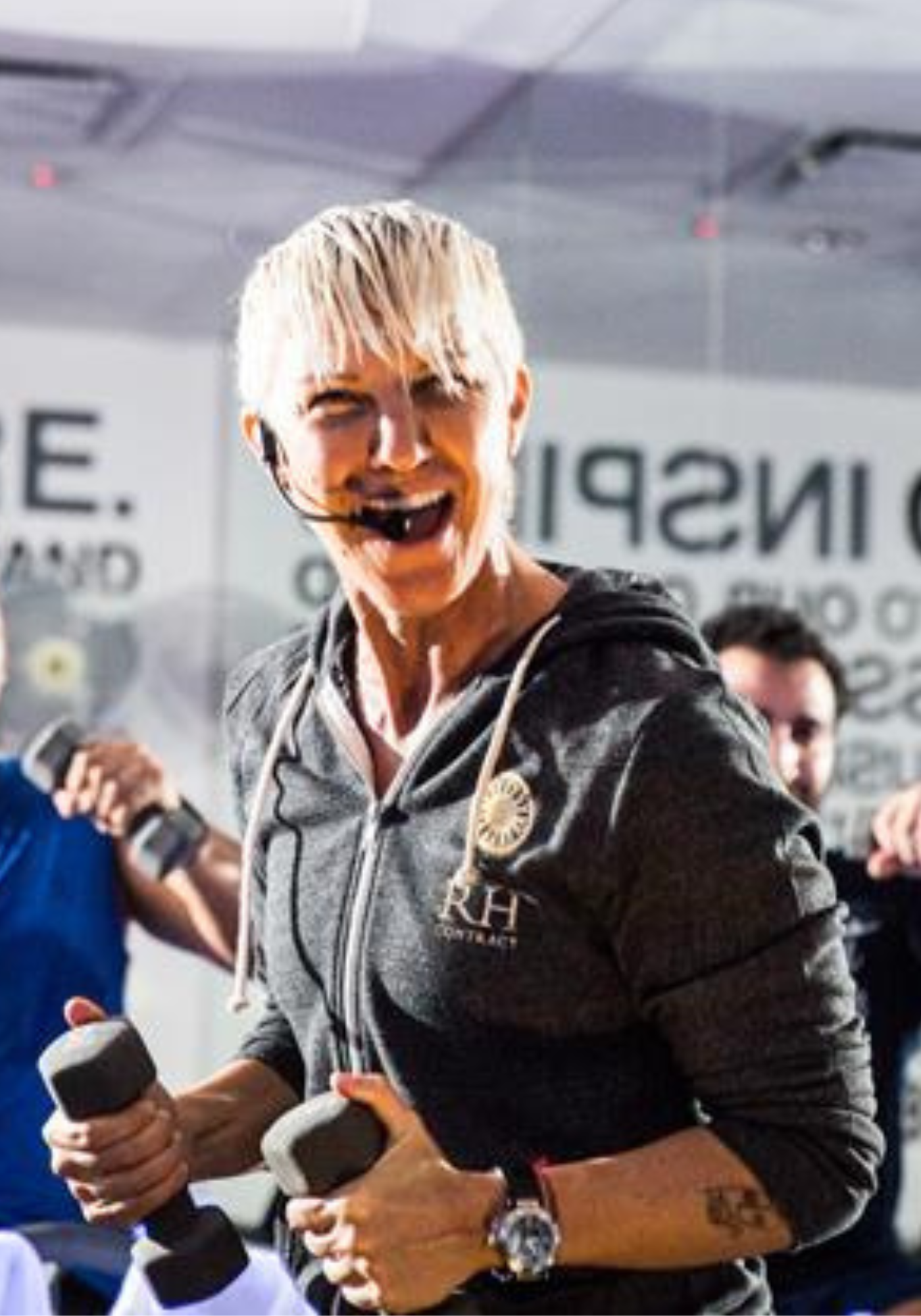 Stacey Griffith holding weights teaching a class